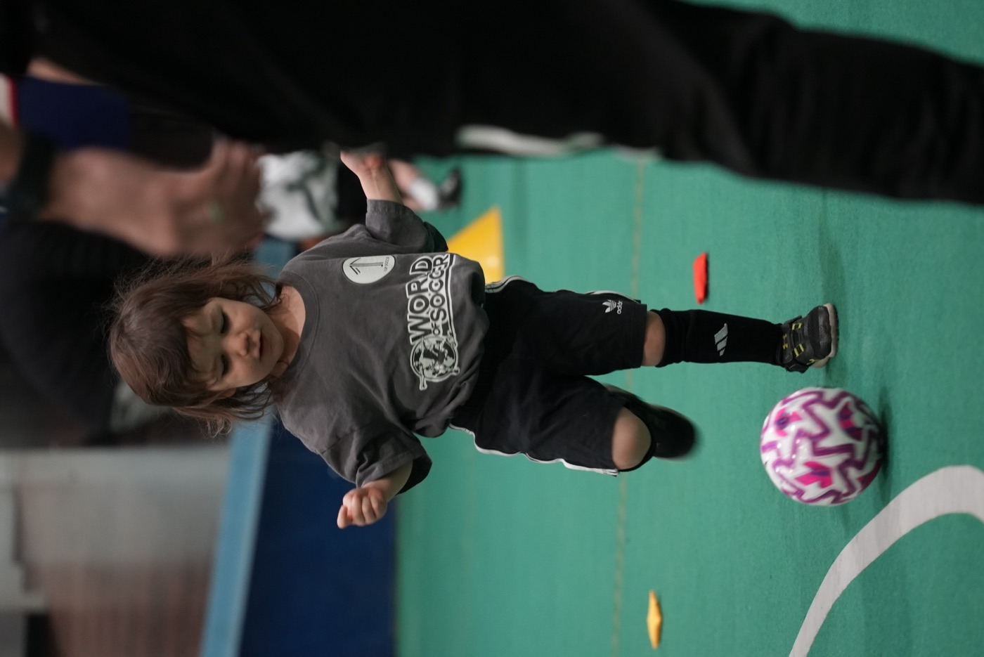 A Mini 1upper kicking a ball at an indoor 1UP session in Calgary